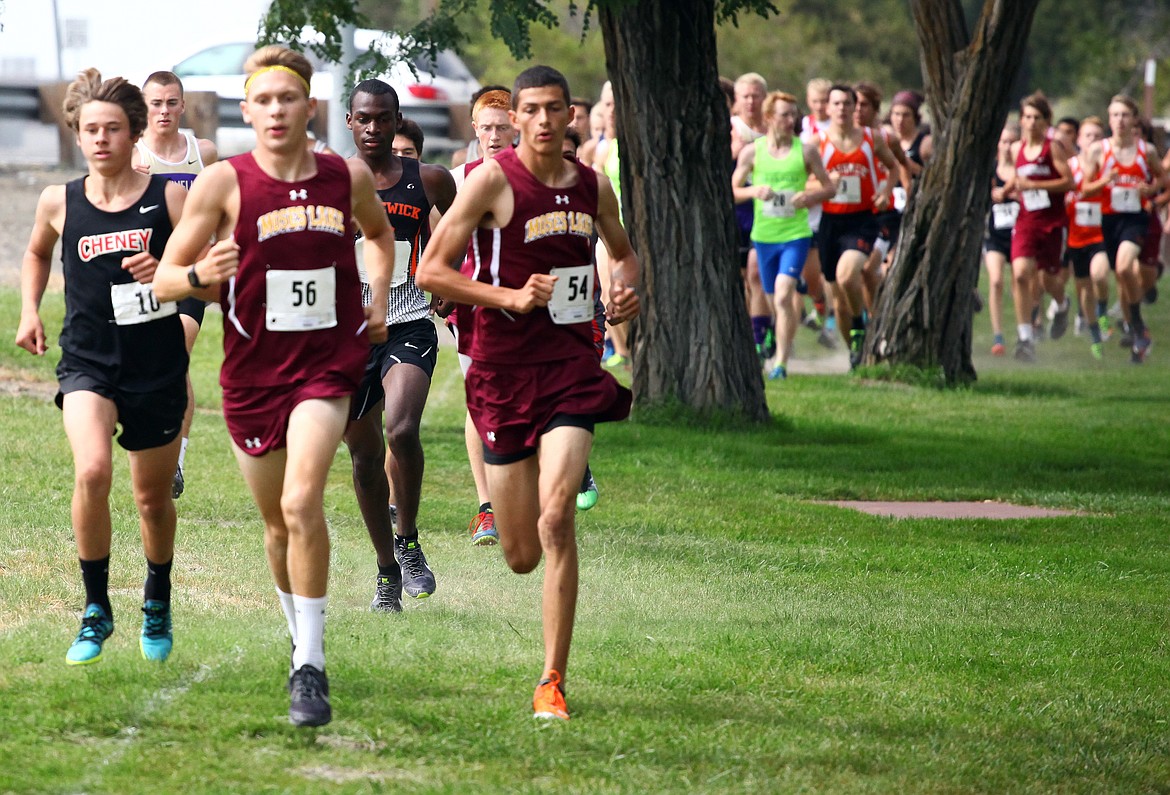 Rodney Harwood/Columbia Basin HeraldMoses Lake's Zach Owens (56) and Joshua Cooper (54) jump to the front of the pack during the boys varsity race at the Moses Lake Invitational at Blue Heron Park on Saturday.