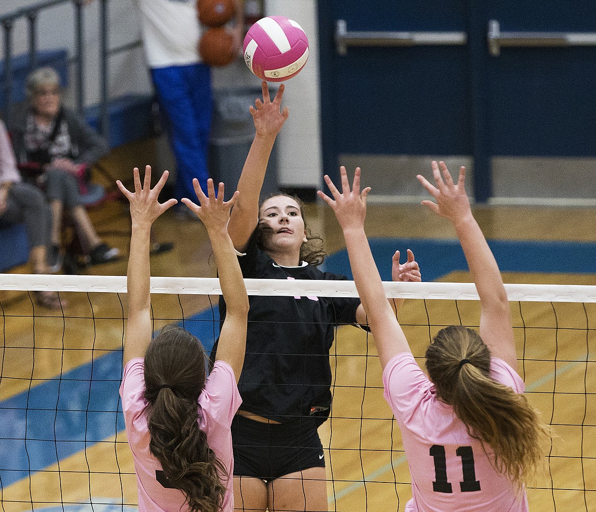 LOREN BENOIT/Press

Post Falls senior Sydney parks spikes the ball between two Coeur d&#146;Alene defenders during Volleyball for the Cure.