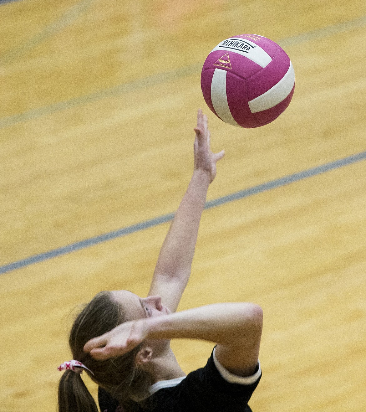 LOREN BENOIT/PressPost Falls senior Mackenzie Morris serves the pink Volleyball for the Cure volleyball to the opposing team.