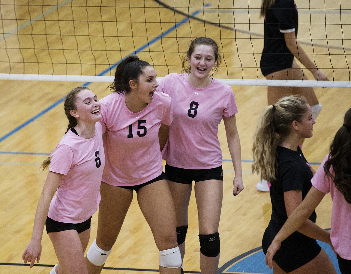 LOREN BENOIT/Press

From left, Coeur d&#146;Alene&#146;s Lauren Phillips, Kelly Horning, and Liliana Hare celebrate a point against Post Falls during Volleyball for the Cure Thursday night at Coeur d&#146;Alene High School.