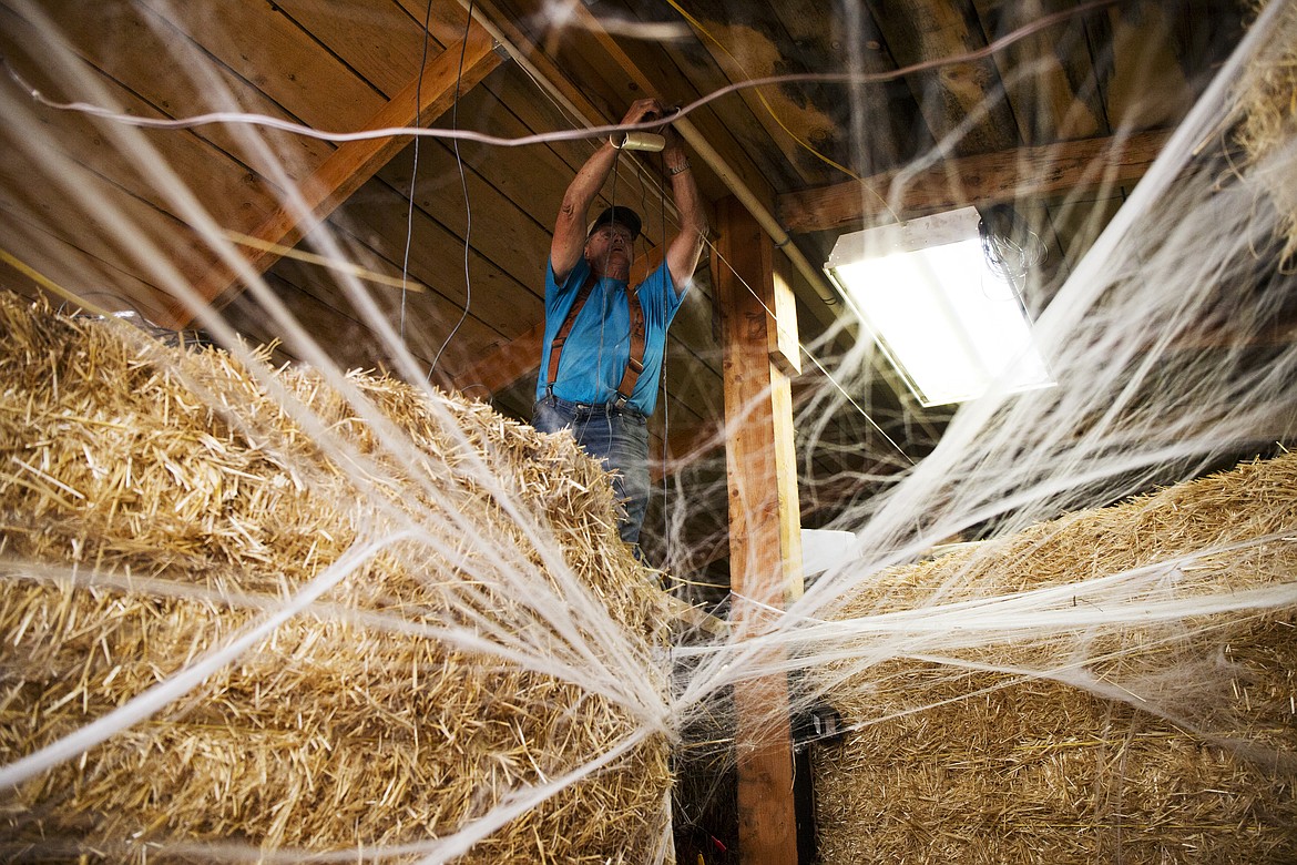 LOREN BENOIT/PressCo-owner Ed Maryott sets up cameras for safety purposes inside the Tunnel of Terror on Wednesday.