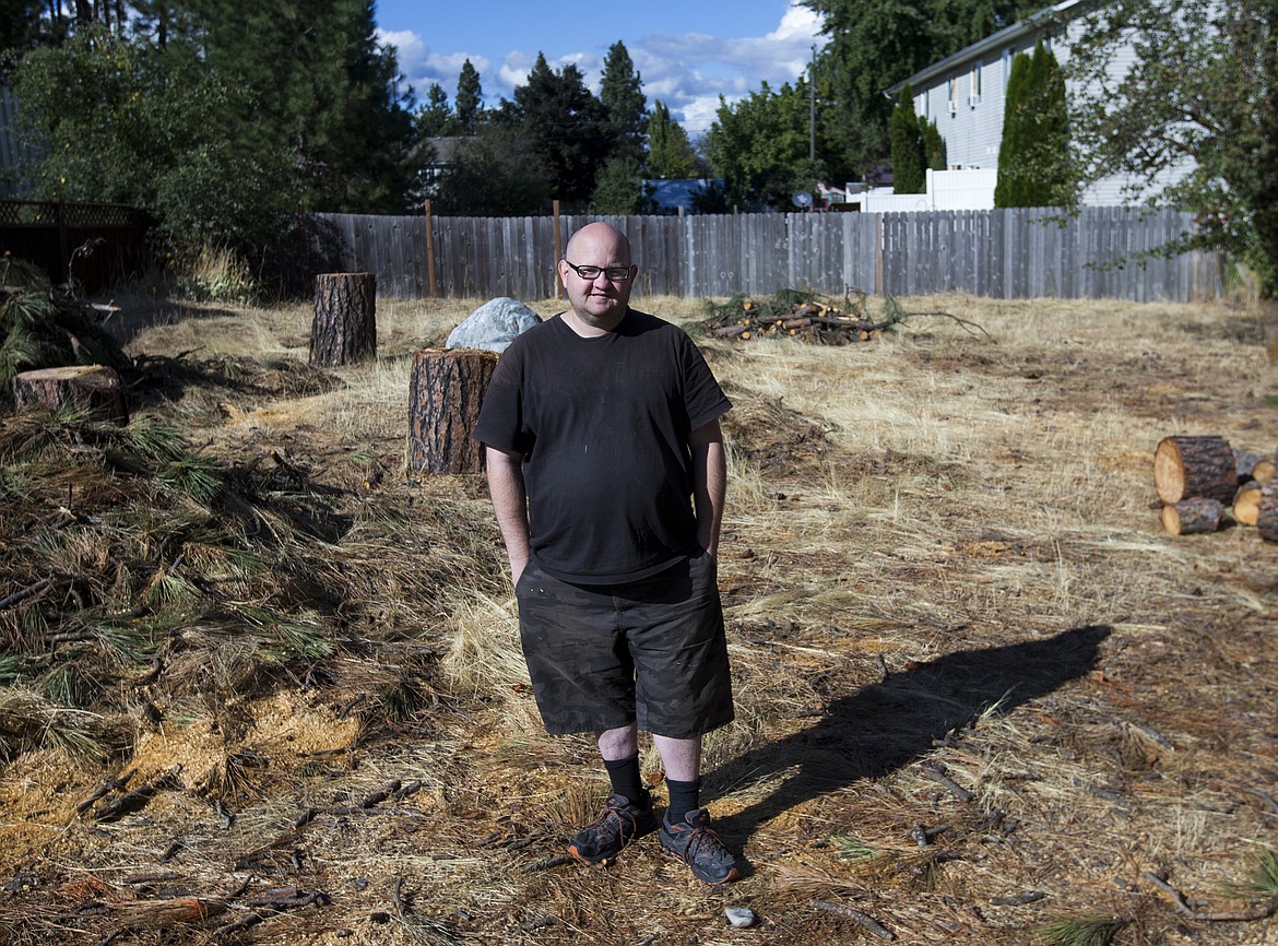 LOREN BENOIT/Press
Nathan Smalley poses for a portrait Friday at the grounds of his future home in Post Falls. Smalley, a Special Olympian who earned gold and silver medals in skiing in Austria earlier this year, has been working with Habitat for Humanity and recently went through the housing application process to get into his new home.