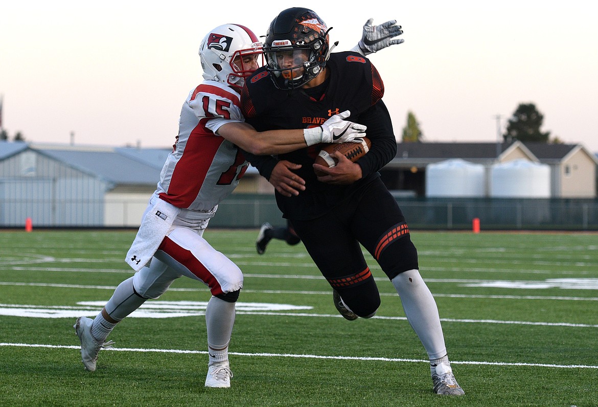 Flathead receiver Anthony Jones sheds a Bozeman tackler during the Braves' touchdown drive to start the game against the Hawks at Legends Stadium on Friday. (Aaric Bryan/Daily Inter Lake)