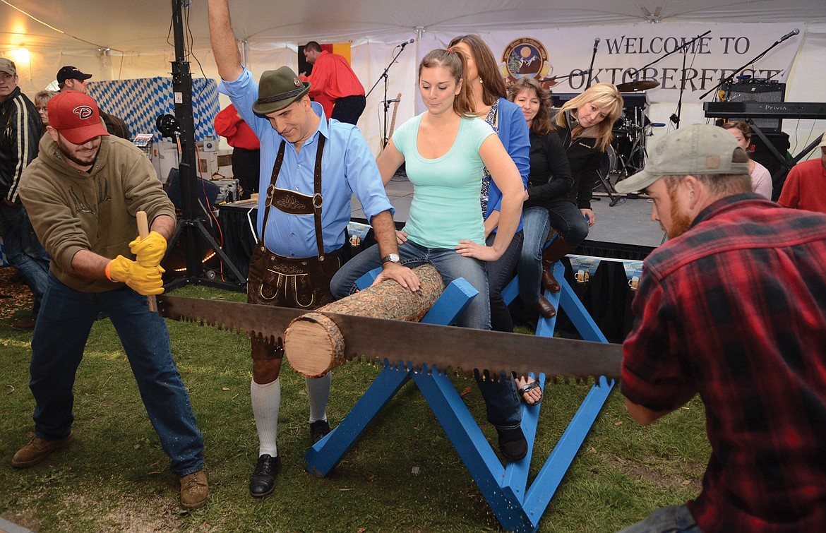 Scott Lawrence and Ethan Dyson compete in a log-sawing contest at a previous Great Northwest Oktoberfest.