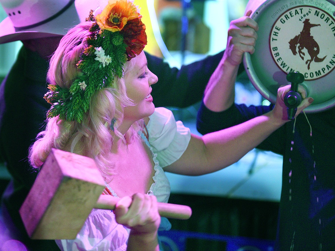 CK Jorgenson taps the ceremonial keg during the Great Northwest Oktoberfest in Whitefish on Thursday. (Aaric Bryan/Daily Inter Lake)