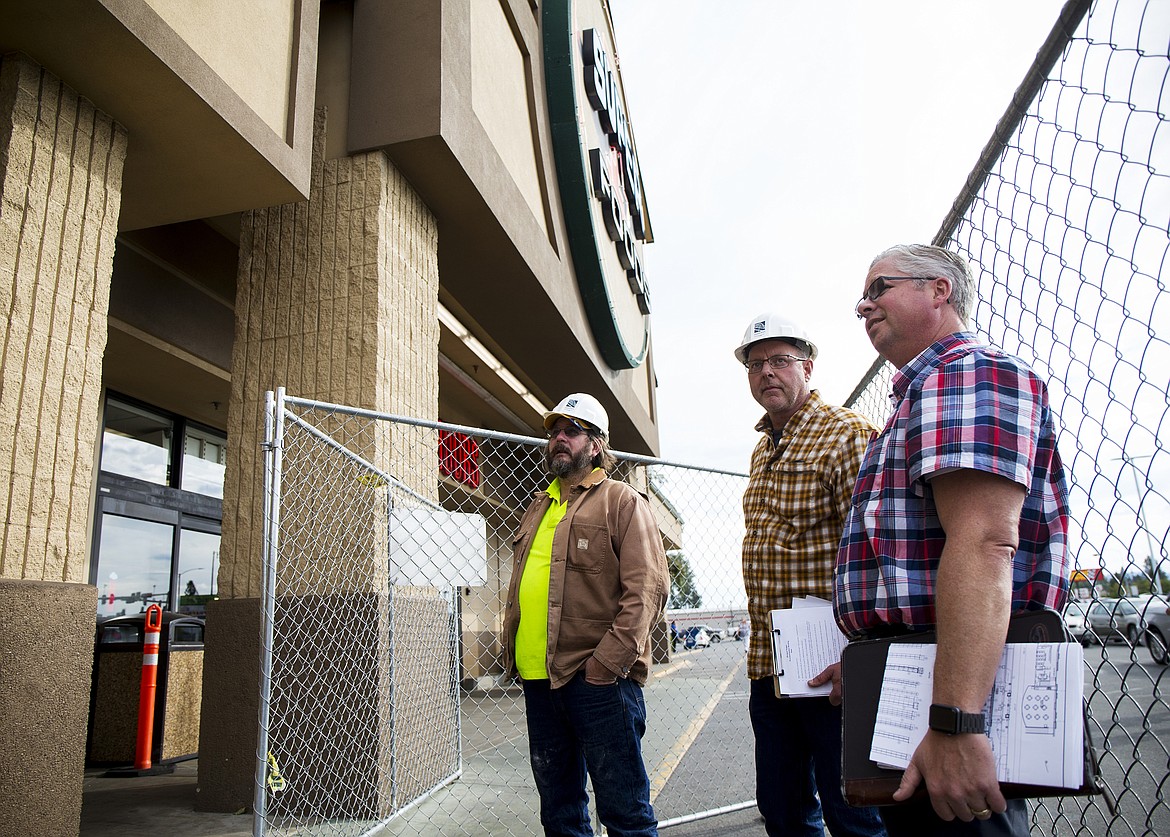 LOREN BENOIT/Press
From left, Gary Hayenga and Todd Ottmar with Meridian Construction, and Tim Reid with URM Stores discuss plans for the remodel for the exterior of The Coeur d&#146;Alene Super 1 Foods store. The store is undergoing a $2.5 million makeover that will bring several new offerings including a new exterior, parking layout and landscaping.