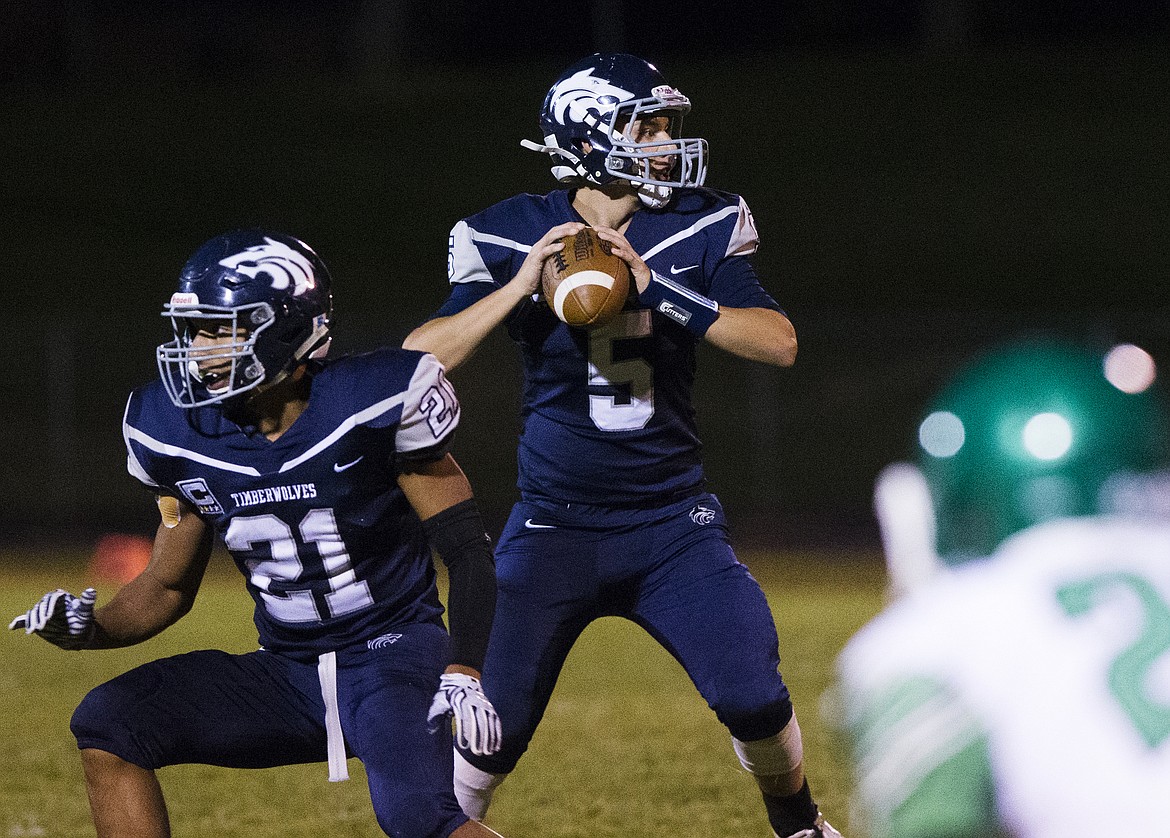 LOREN BENOIT/Press
Lake City quarterback Bryce Buttz surveys the defense before throwing the ball to one of his wide receivers during last Friday&#146;s game.