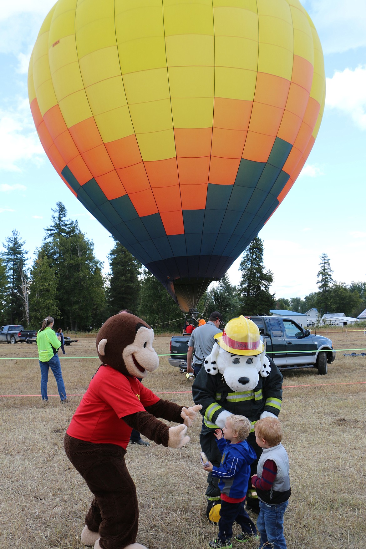 (Photo by MARY MALONE)
The young crowd at Ponderay Neighbor Day enjoyed meeting Sparky and Curious George on Saturday.