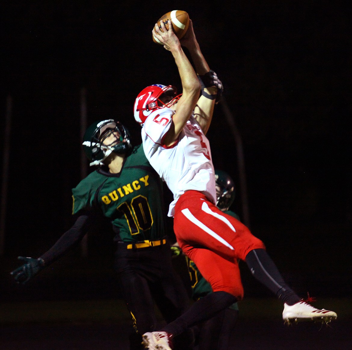 Rodney Harwood/Columbia Basin HeraldOthello wide receiver Kyler Villarreal (5) hauls in a 16-yard touchdown pass over Quincy defender Gates Petersen (10) during Friday's CWAC North game at Jaycee Stadium.