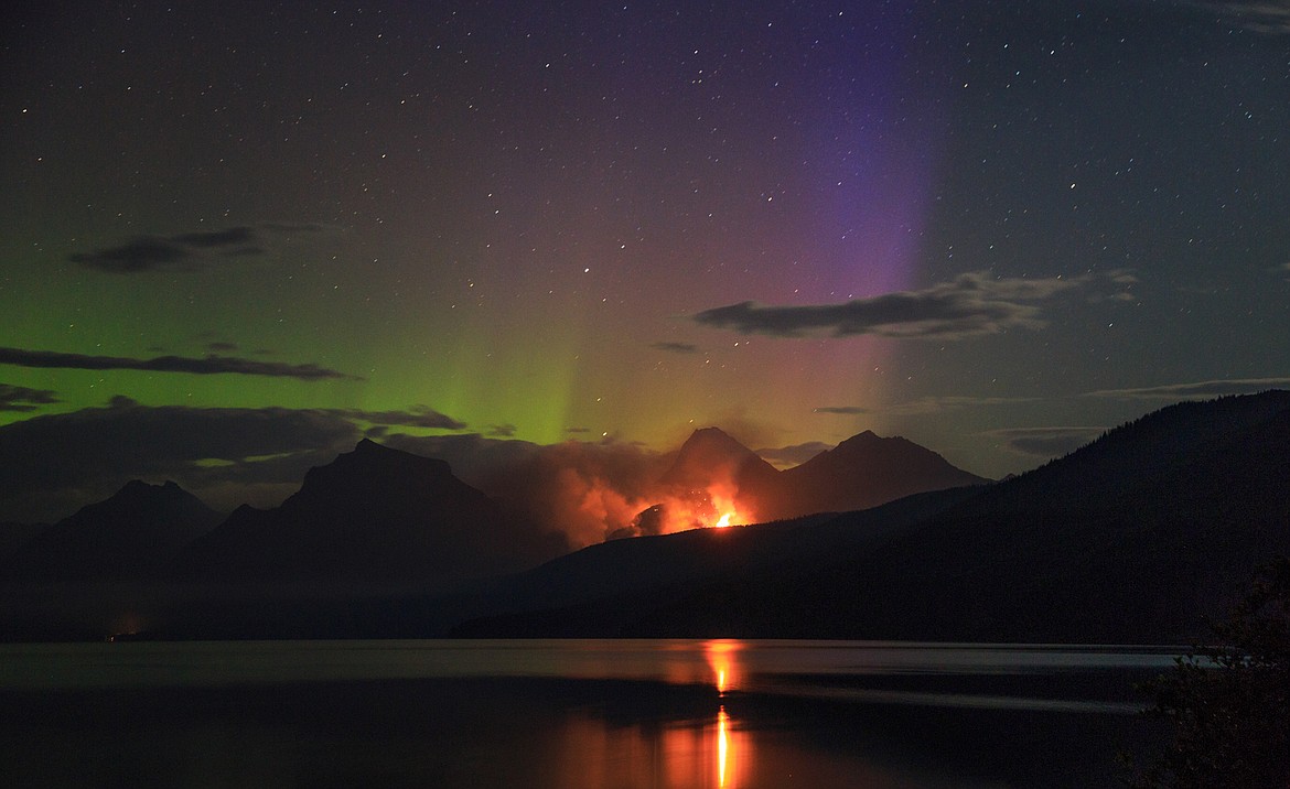 Philip Granrud/Hagadone News Network
The northern lights dance over the Sprague Fire at 3:55 a.m. Aug. 17, seen from the boat launch at Apgar Village, Glacier National Park.