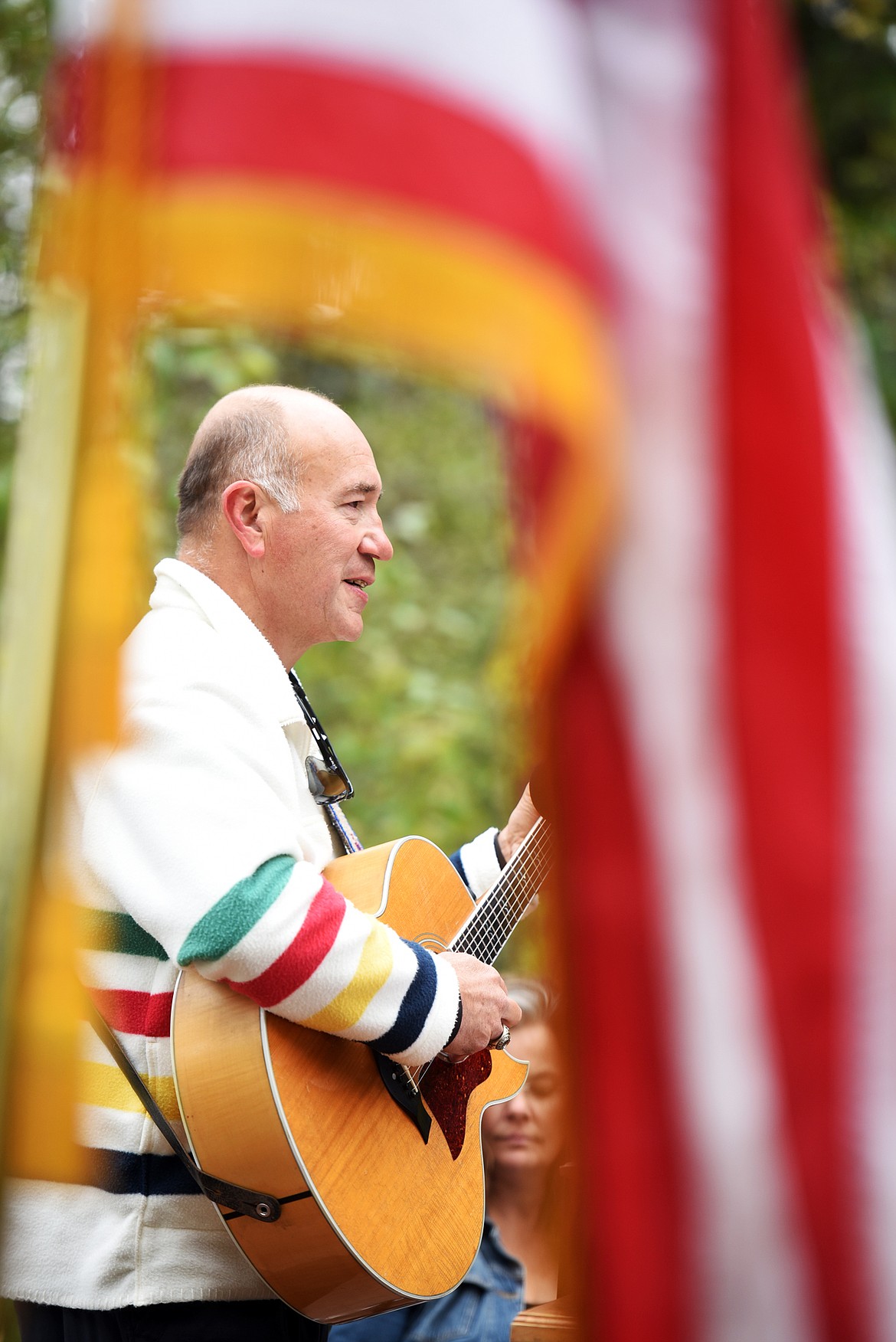 Singer/songwriter Jack Gladstone performed his song, The Builder, before ten new citizens made the Oath of Allegiance at the Naturalization Ceremony on Friday, September 22 at Lake McDonald in Glacier National Park.(Brenda Ahearn/Daily Inter Lake)