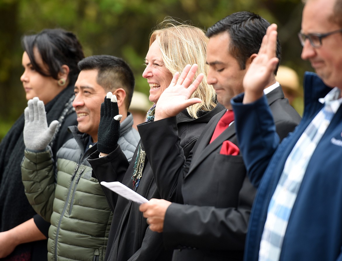 From left, Briza Karina Galvan Talamantes of Mexico, Rigoberto Garate Salas of Mexico, Elin Charlotta Hibbs of Sweden, Rodrigo Antonio Jofre Diaz of Chile, and Daniel Kuster of Sweden taking the Oath of Allegiance at the Naturalization Ceremony on Friday, September 22 at Lake McDonald in Glacier National Park.(Brenda Ahearn/Daily Inter Lake)