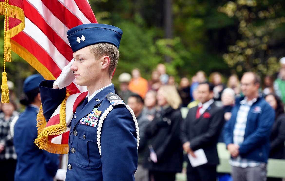 Civil Air Patrol Cadet Lt. Col. Justin Ramey, 17, of Fortine, salutes the American Flag at the presentation of colors preceding the Naturalization Ceremony on Friday, September 22 at Lake McDonald in Glacier National Park.(Brenda Ahearn/Daily Inter Lake)