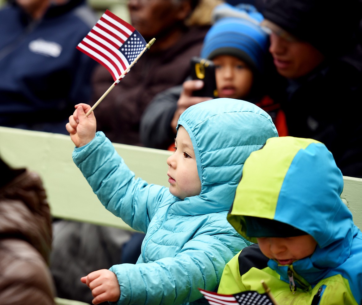 Luka Trilisky waves an American Flag at the&#160;Naturalization Ceremony held in Glacier National Park on Friday, September 22, where his mother, Yumi Ueki of Japan is about to make the Oath of Allegiance.(Brenda Ahearn/Daily Inter Lake)