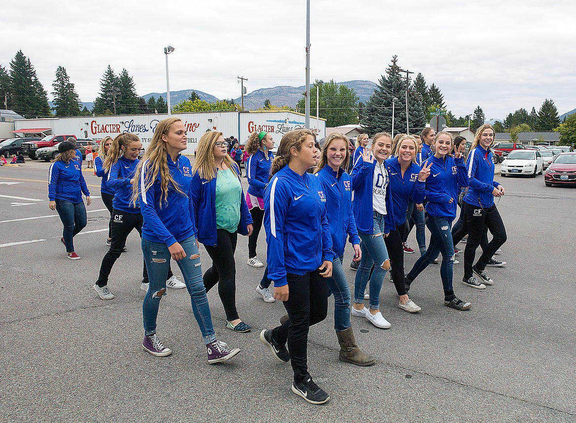 The girls soccer team waves to the crowd.