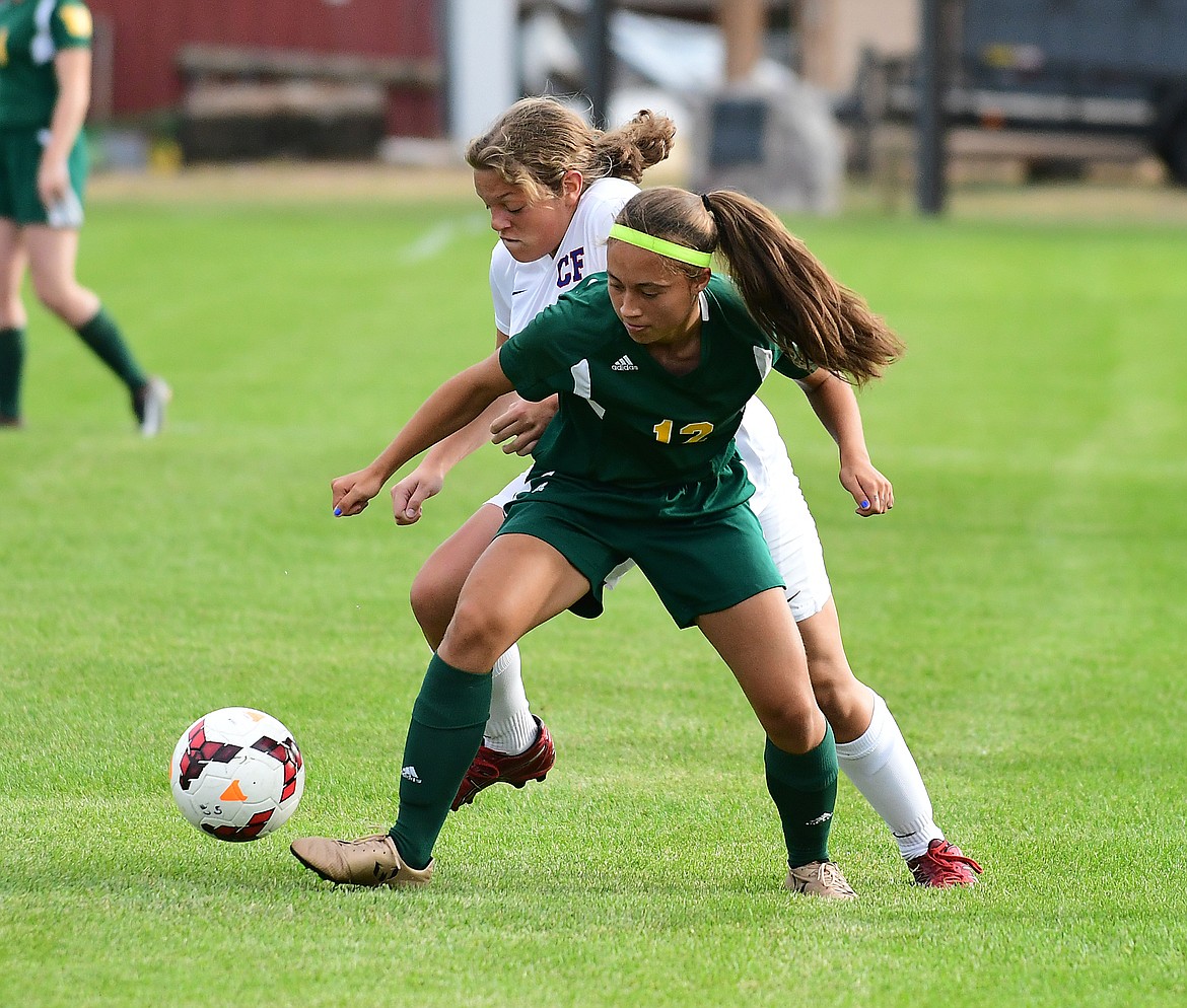 Graceanne Sevesind battles for possession against a Whitefish player.