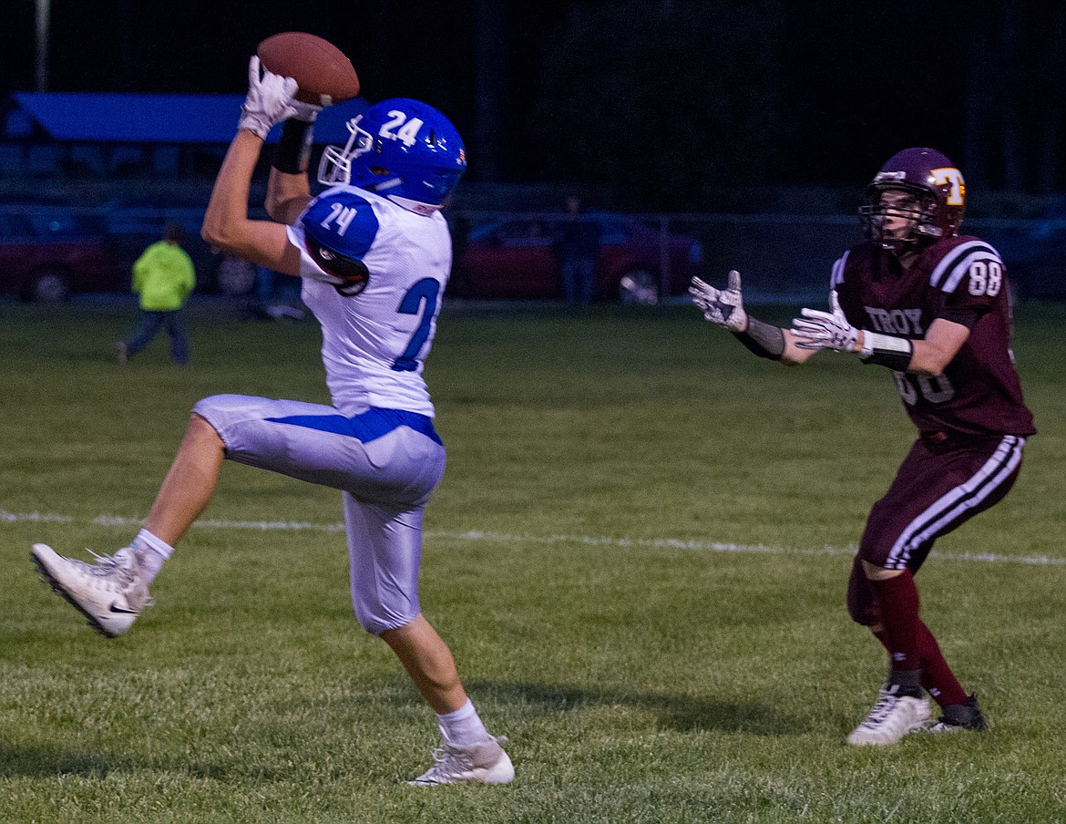 St. Ignatius wide receiver Wacey McClure, left, intercepts a pass intended for Troy&#146;s Hunter Leighty, right, Friday night in Troy. (John Blodgett/The Western News)