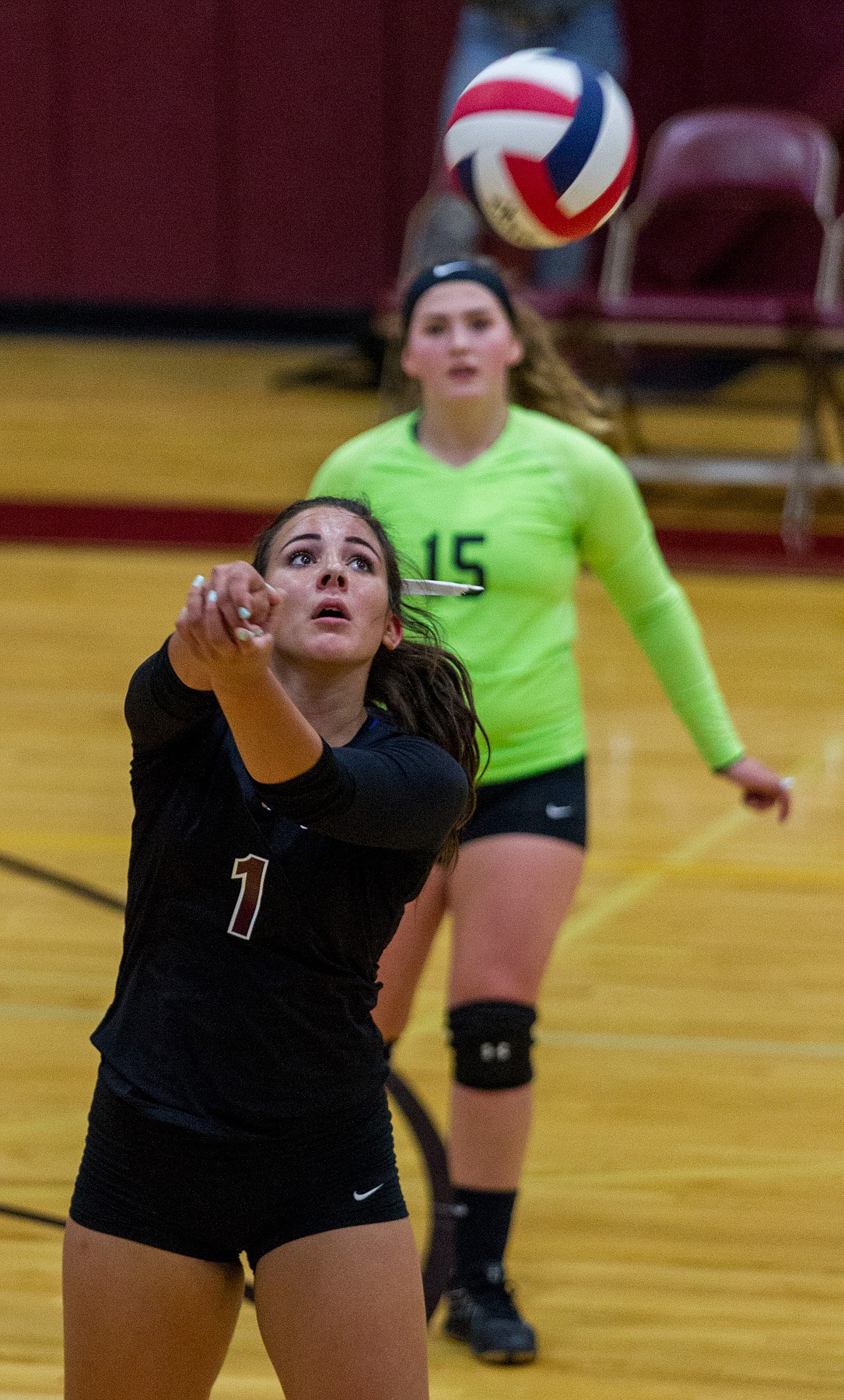 Troy senior Aurora Becquart returns a volley in a game against Bigfork Saturday in Troy as Kaitlyn Downey looks on. (John Blodgett/The Western News)