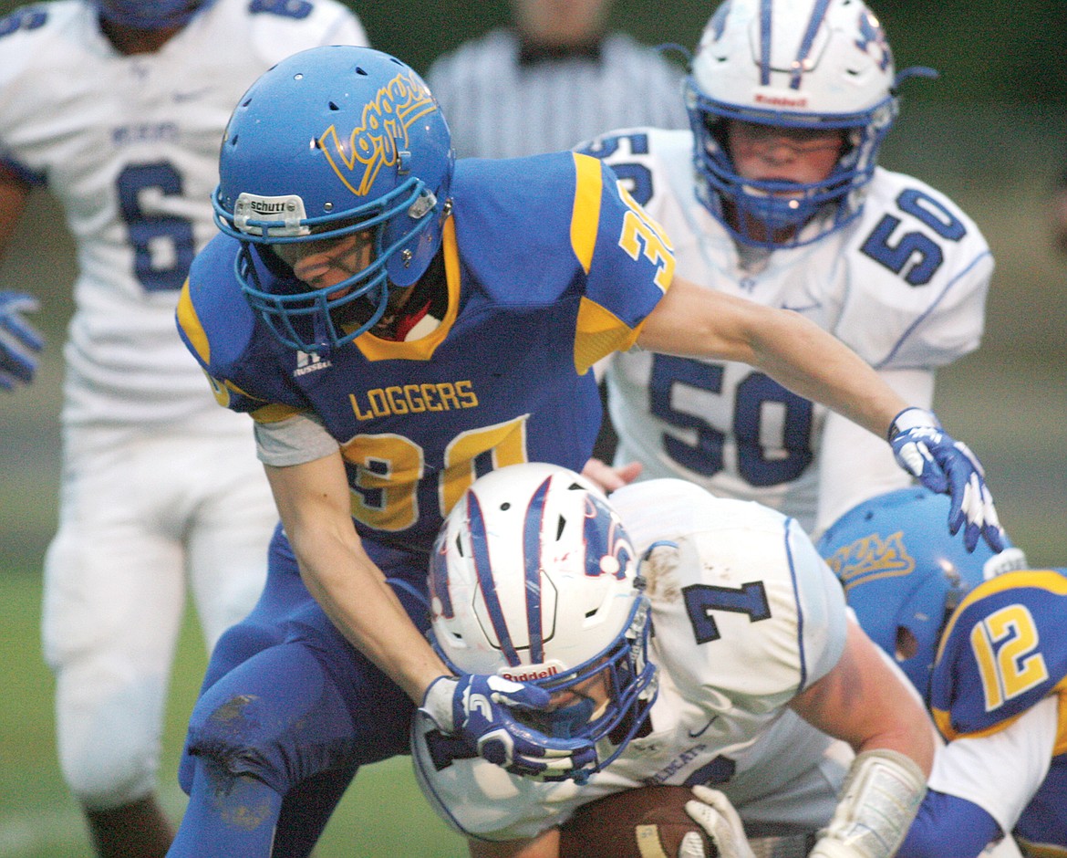 Ethan Beck, left and Jay Beagle tackle Columbia Falls' Colten McPhee in first quarter action Friday, Sept. 22. Loggers fall 54-0. (Paul Sievers/The Western News)