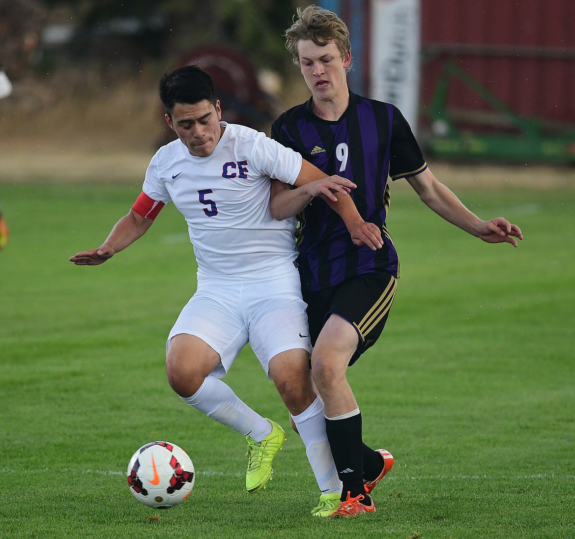 Alex Garate, left,  fights for possession against a Polson player last week.