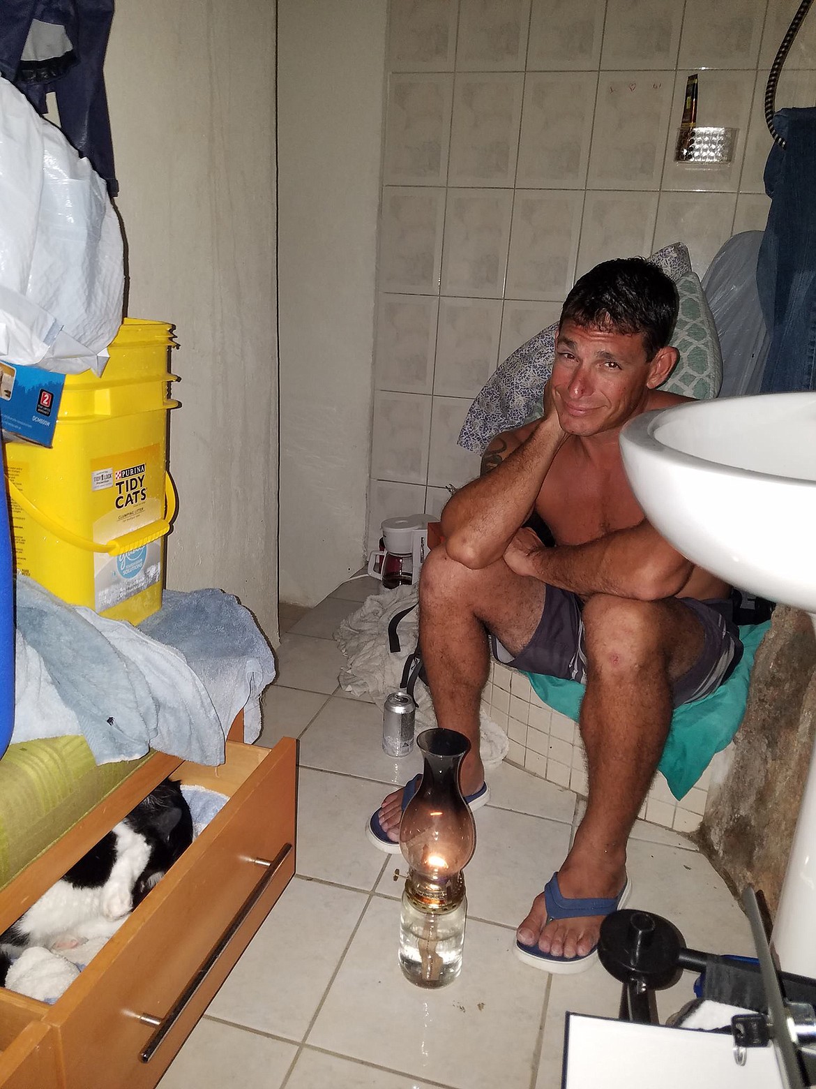 Nate Apolito and Sarah Crill (notpictured) wait out hurricane Irma in their bathroom, along with thier cat, Mahi Mahi and two strays the couple rescued. Eight days after the Category 5 storm hit the island, Apolito fell 30 feet from the roof of their apartment and suffered extensive injuries. (Courtesy of Sarah Crill)