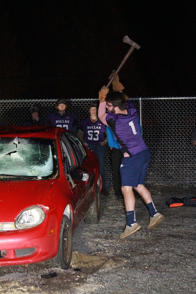 Sophmore Kye Gallaway takes a splitting maul to a car that was donated to the school. It cost only one dollar for someone to take a swing!