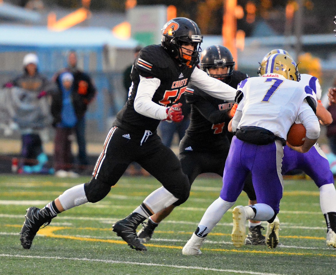 RONAN DEFENSIVE lineman Jordon Skelton attempts to tackle Polson quarterback Bo Kelley in the first half of the Ronan, Polson game Friday night at Ronan High School. (Jason Blasco/Lake County Leader)