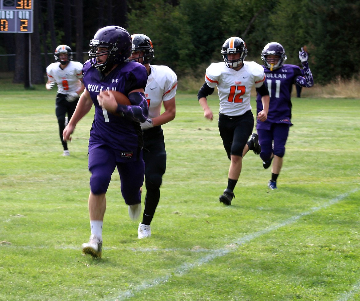 Skye Gallaway retunrs a kick up the sideline during Mullan's homecoming football game on Friday night.