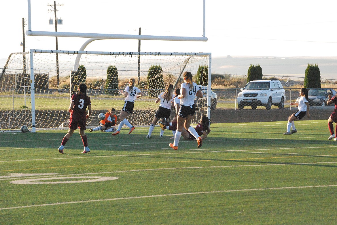 Bob Kirkpatrick/The Sun Tribune - The Warriors Ana Andrade rockets a shot past Royal keeper Denisse Arroyo in the first half of action.