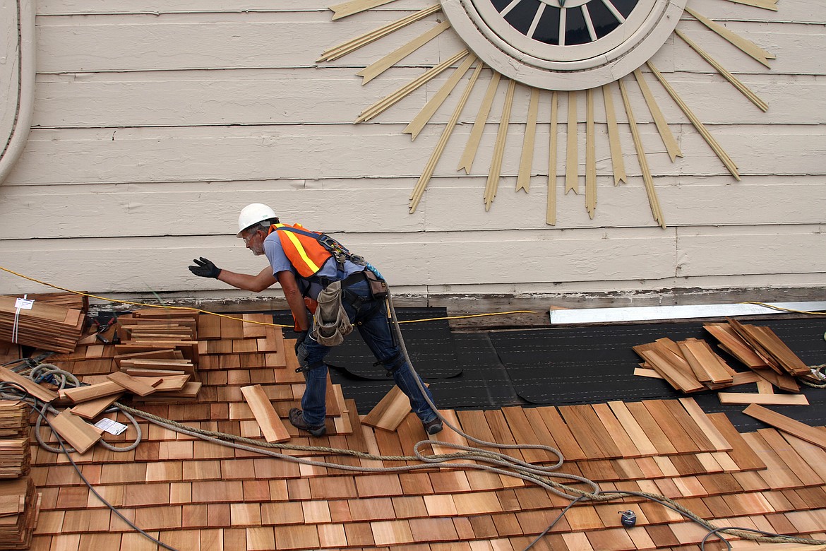 Photos by Josh McDonald
A construction worker roofing the section of roof above the entryway into the church.