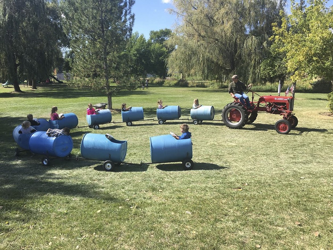 Tom Chism leads a tractor ride for kids at Harvest Fest. (Ashley Fox/Lake County Leader)