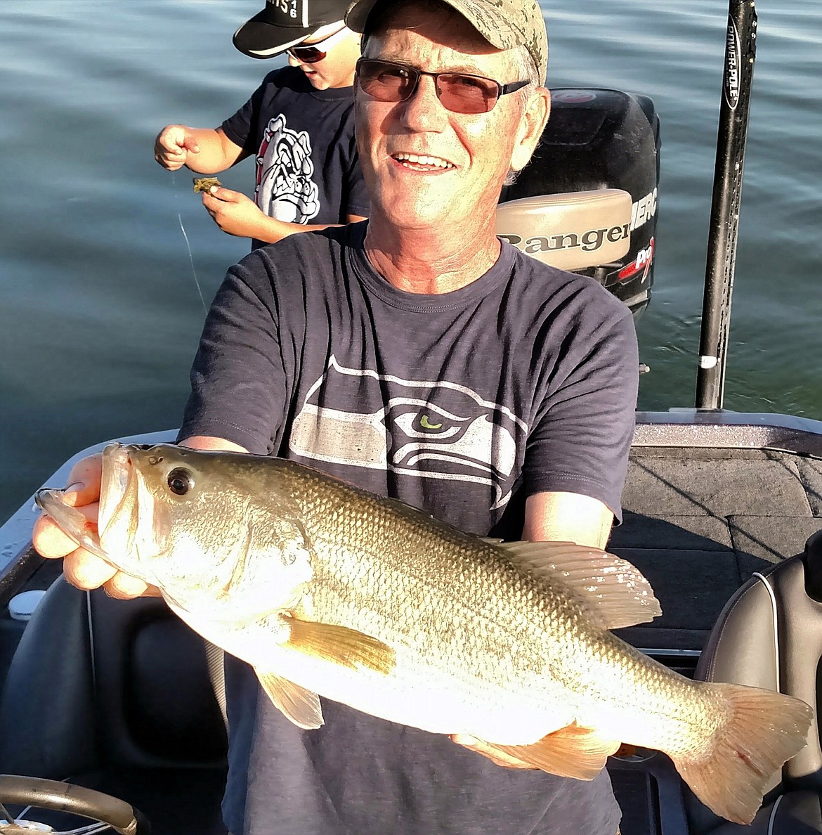 Pete Fisher photo - Mike Meseberg of MarDon Resort with a nice largemouth bass caught on the face of the dunes.