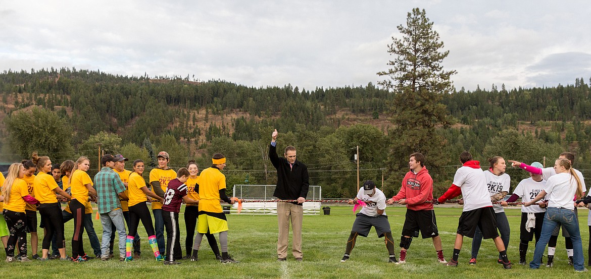 Top left: Jacob Francom, superintendent of Troy Public Schools, gives the go ahead to a tug of war between freshman, left, and juniors during homecoming festivities Wednesday evening in Troy. (John Blodgett/The Western News)