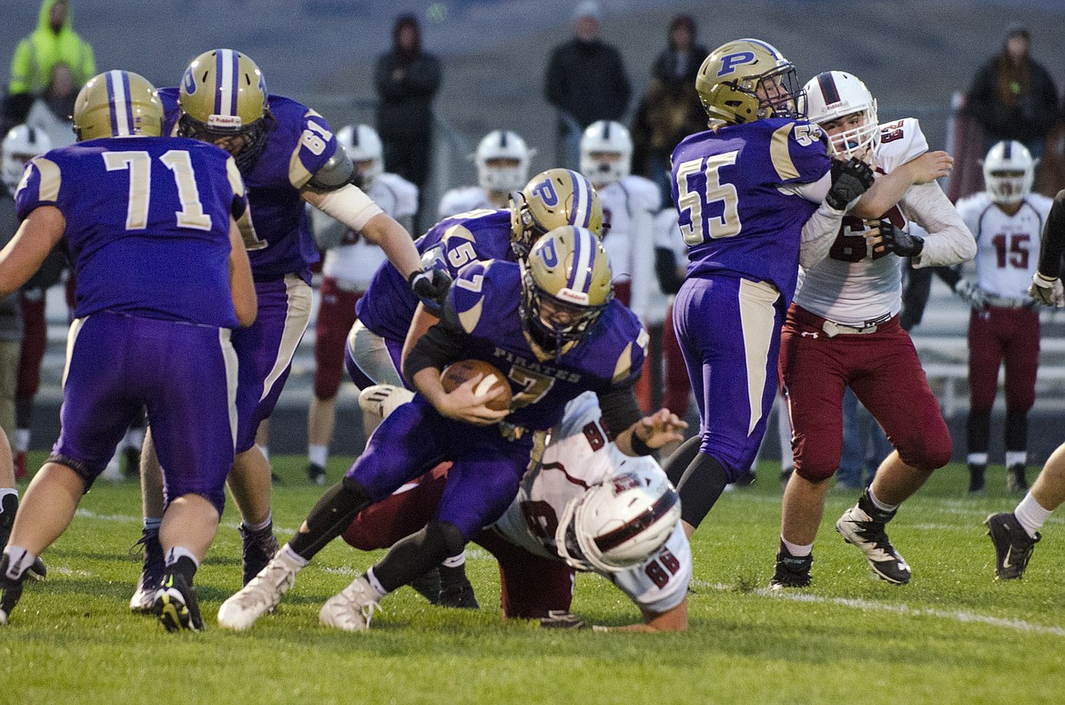 POLSON QUARTERBACK Bo Kelley attempts to scramble out of trouble against Hamilton in Friday night&#146;s game at Polson High School. (Jeremy Weber/Lake County Leader)