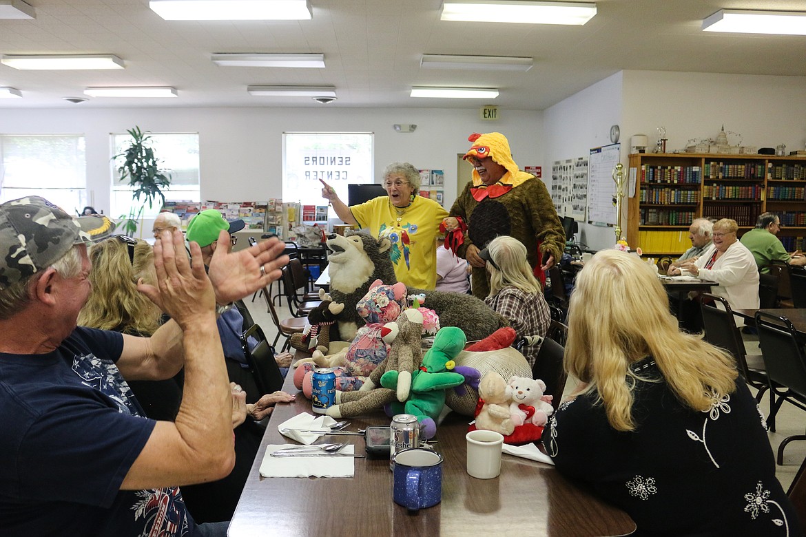 Photos by Mandi Bateman
Nancy Martinez enlisted the help of a chicken during Pet Day at the Seniors Hospitality Center.