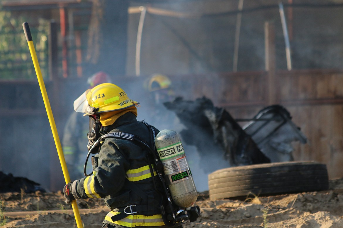 Photo by Mandi Bateman
Firefighters working to put out a boat fire on  September 16.