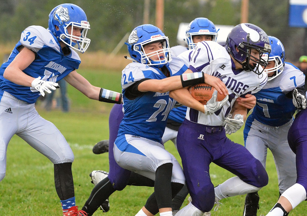 CHARLO HIGH School Garett Vaughan attempts to break Wacey McClure (24), Layne Spidel (34), and Cole Gilleard (7) attempt to tackle him during a kickoff return. (Jason Blasco/Lake County Leader)