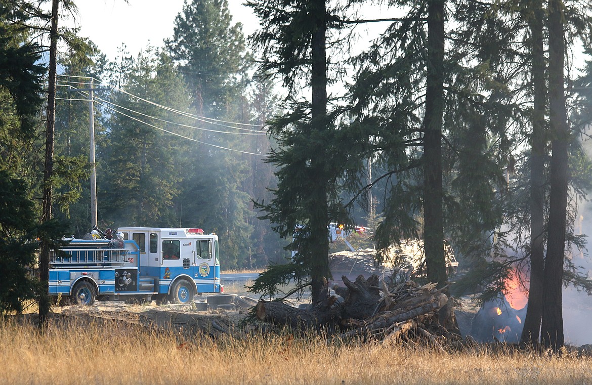 Photo by Mandi Bateman
Firefighters worked quickly to keep the fire from spreading into the trees.