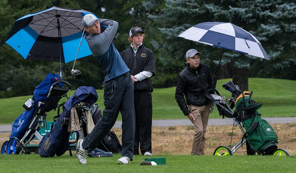 Libby&#146;s Ryggs Johnston, left, tees off as Whitefish&#146;s Cameron Kahle, center, and Columbia Falls&#146; Logan Lybbert look on during Tuesday&#146;s golf invitational at Cabinet Peaks Golf Course in Libby. (John Blodgett/The Western News)