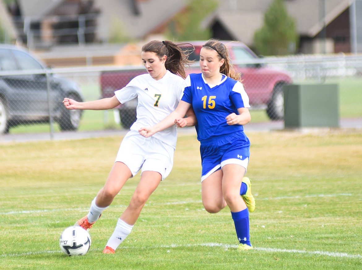 Olivia Pothoff fights past a Libby defender last Tuesday. (Daniel McKay/Whitefish Pilot)