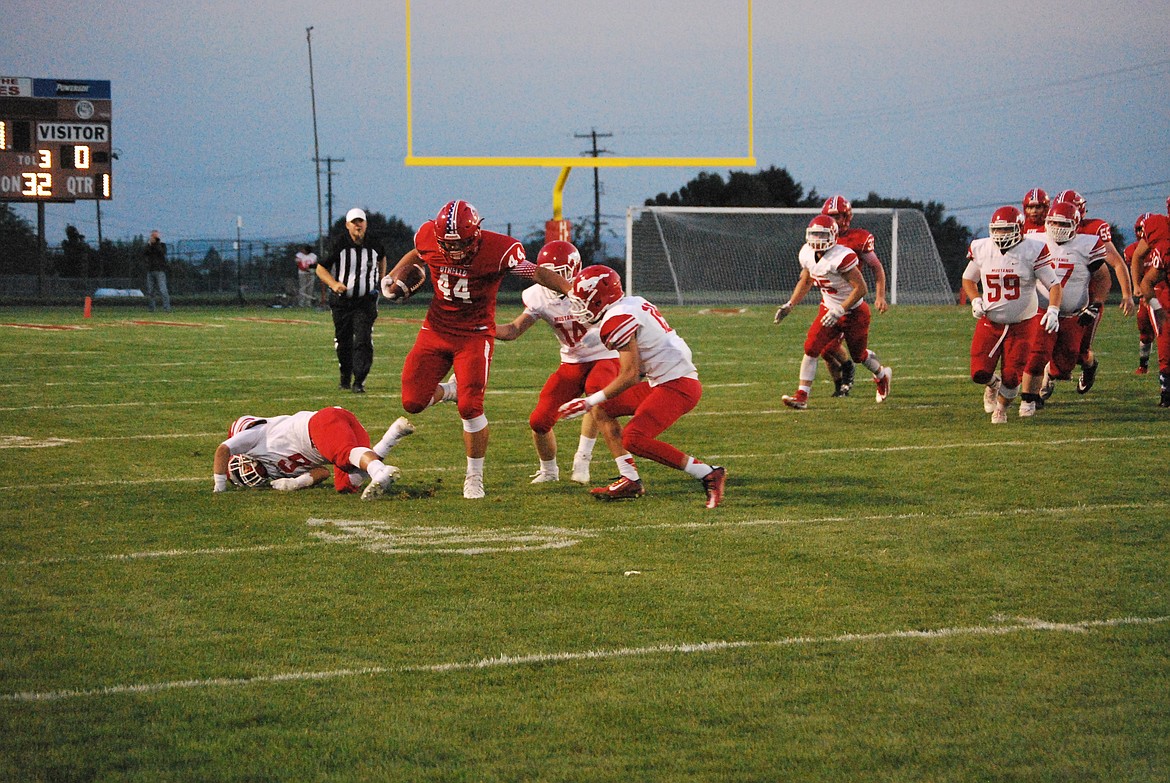 Bob Kirkpatrick/The Sun Tribune - Isaiah Perez breaks three tackles in route to a 38-yard touchdown in the first quarter of action.