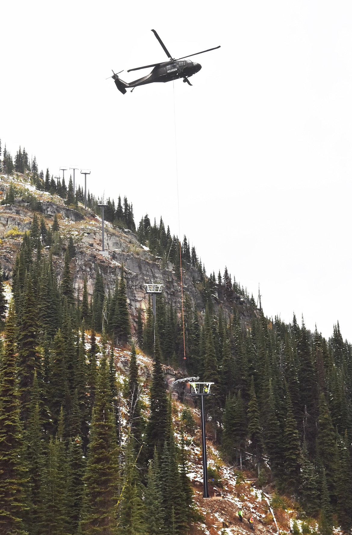 A helicopter delivers a chairlift tower Sunday morning to the East Rim at Whitefish Mountain Resort. Chair 5 is being relocated from Ptarmigan Bowl to the East Rim as part of a $1.2 million project aimed at improving skier access in the area. (Heidi Desch/Whitefish Pilot)