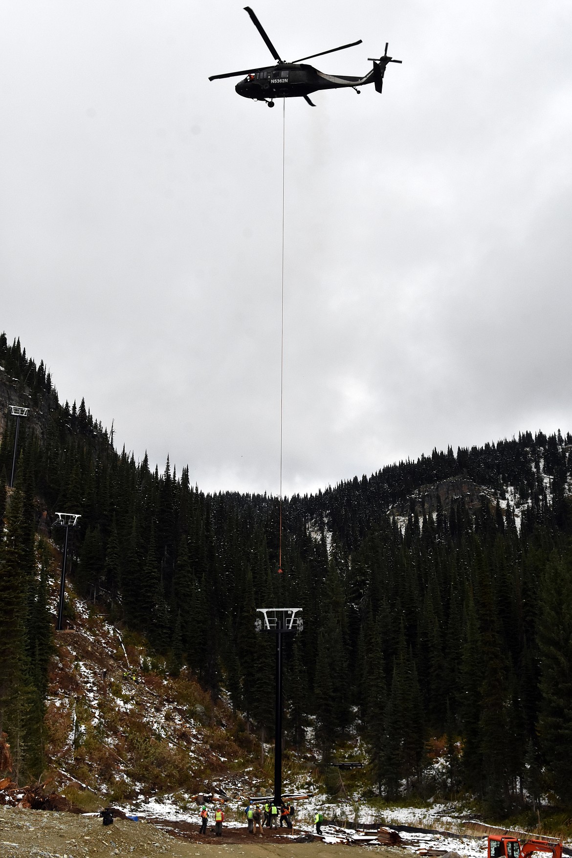 A helicopter flies the final chairlift tower into place for Chair 5 Sunday morning near the bottom terminal located close to the intersection of Russ&#146;s Street and Moe-Mentum on the East Rim of Whitefish Mountain Resort. (Heidi Desch/Whitefish Pilot)