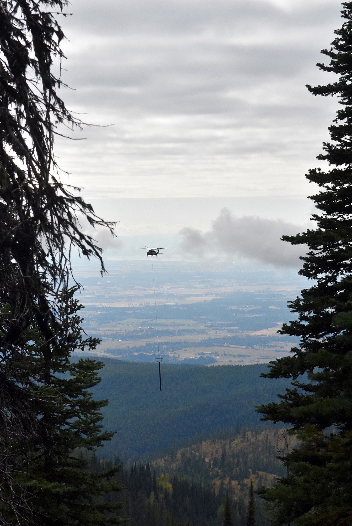 A helicopter flies a chairlift tower Sunday morning from the staging area to East Rim at Whitefish Mountain Resort for the relocation of Chair 5 from Ptarmigan Bowl. (Heidi Desch/Whitefish Pilot)