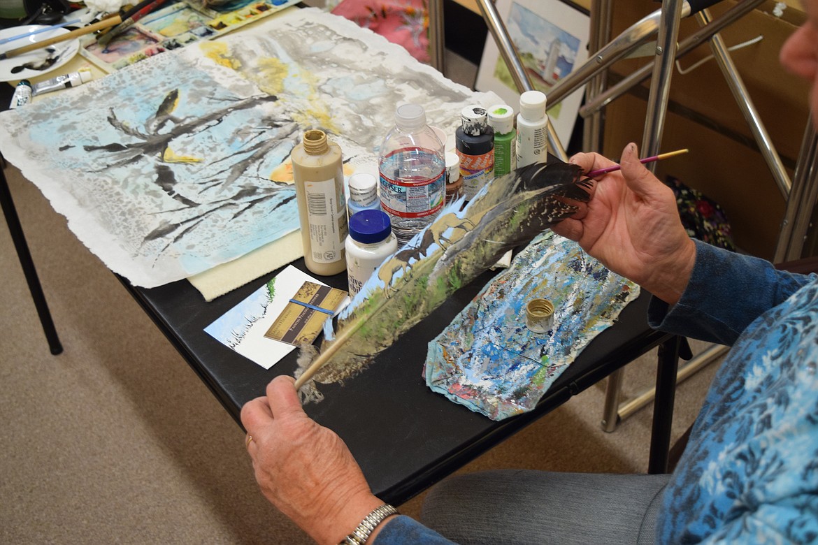 File photo
Leanne Hickman displays one of her painted feather artworks at last year&#146;s Moses Lake Business Association Art &amp; Wine Walk. This year&#146;s event is Oct. 7.