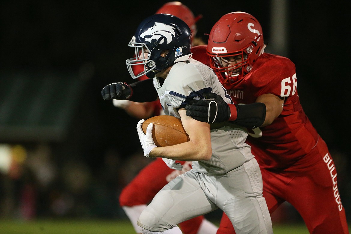 (Photo by JASON DUCHOW PHOTOGRAPHY)
Senior defensive end Evan Stickelmeyer wraps up a ball barrier in the Bulldogs&#146; loss to Lake City on Friday night.