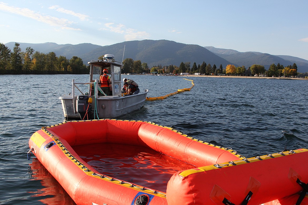 (Photo by KEITH KINNAIRD)
The NOFI Current Buster 2's spill collection basin is seen in the foreground. In the background crews haul in a lengthy line of boom.