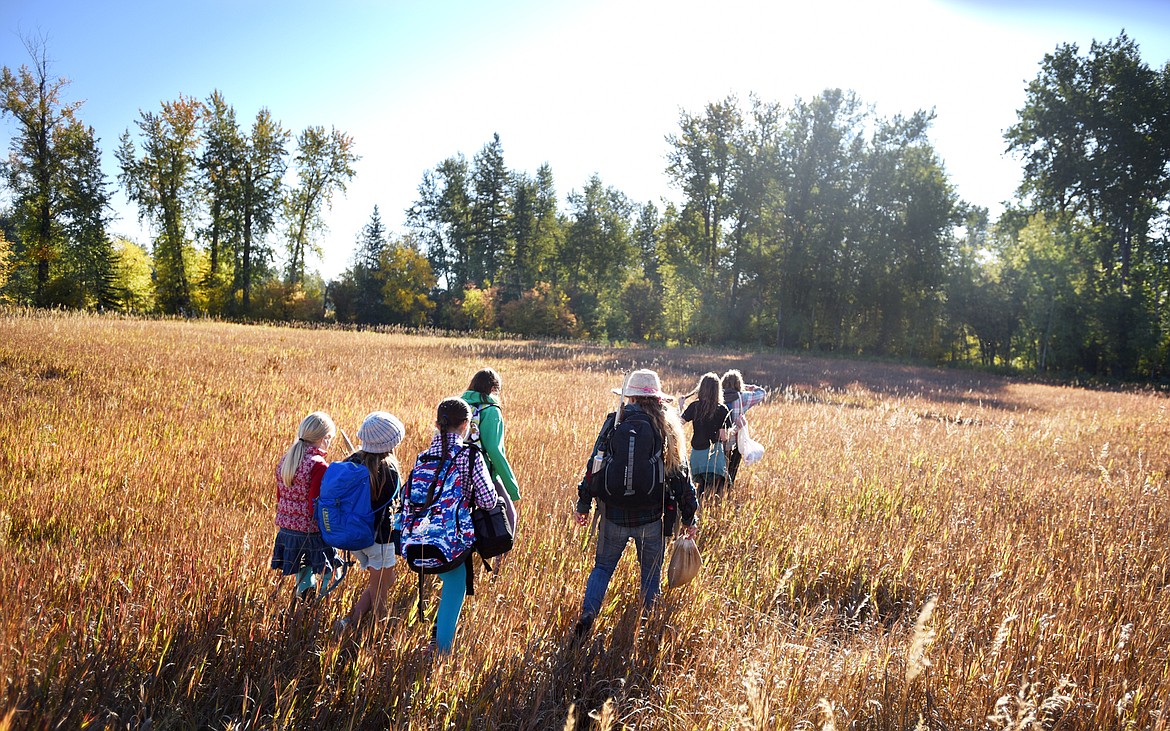 Jennifer Bresee of Ravenwood leads a group of students from Kalispell Montessori into the woods near the school for an outdoor experience on Thursday, September 28, in Kalispell.(Brenda Ahearn/Daily Inter Lake)