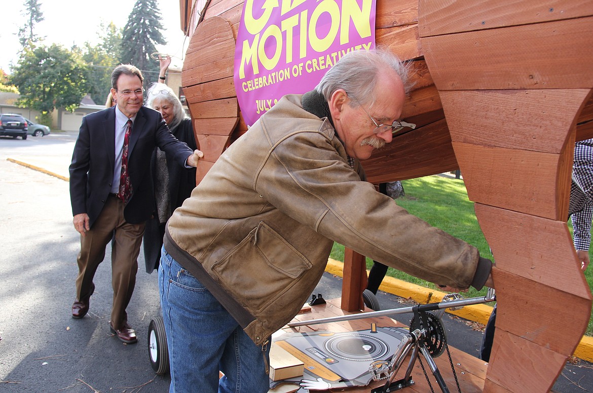 Gizmo-CDA co-founder Marty Mueller (front) pushes the nonprofit&#146;s large wooden horse into a bay area of the Hedlund Building on NIC&#146;s campus Friday along with NIC president Rick MacLennan and Gizmo-CDA co-founder Barbara Mueller.

Courtesy photo