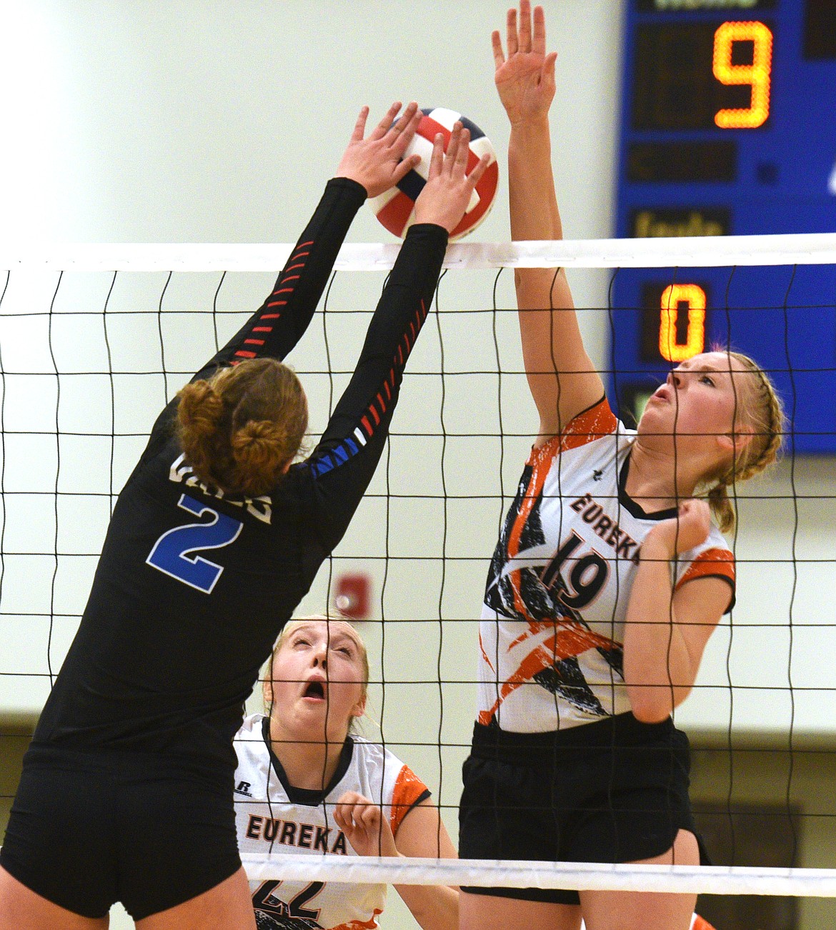 Eureka outside hitter Kassi Peterson and Bigfork setter Aubrey Halverson both go for a ball at the net at Bigfork on Saturday. (Aaric Bryan/Daily Inter Lake)